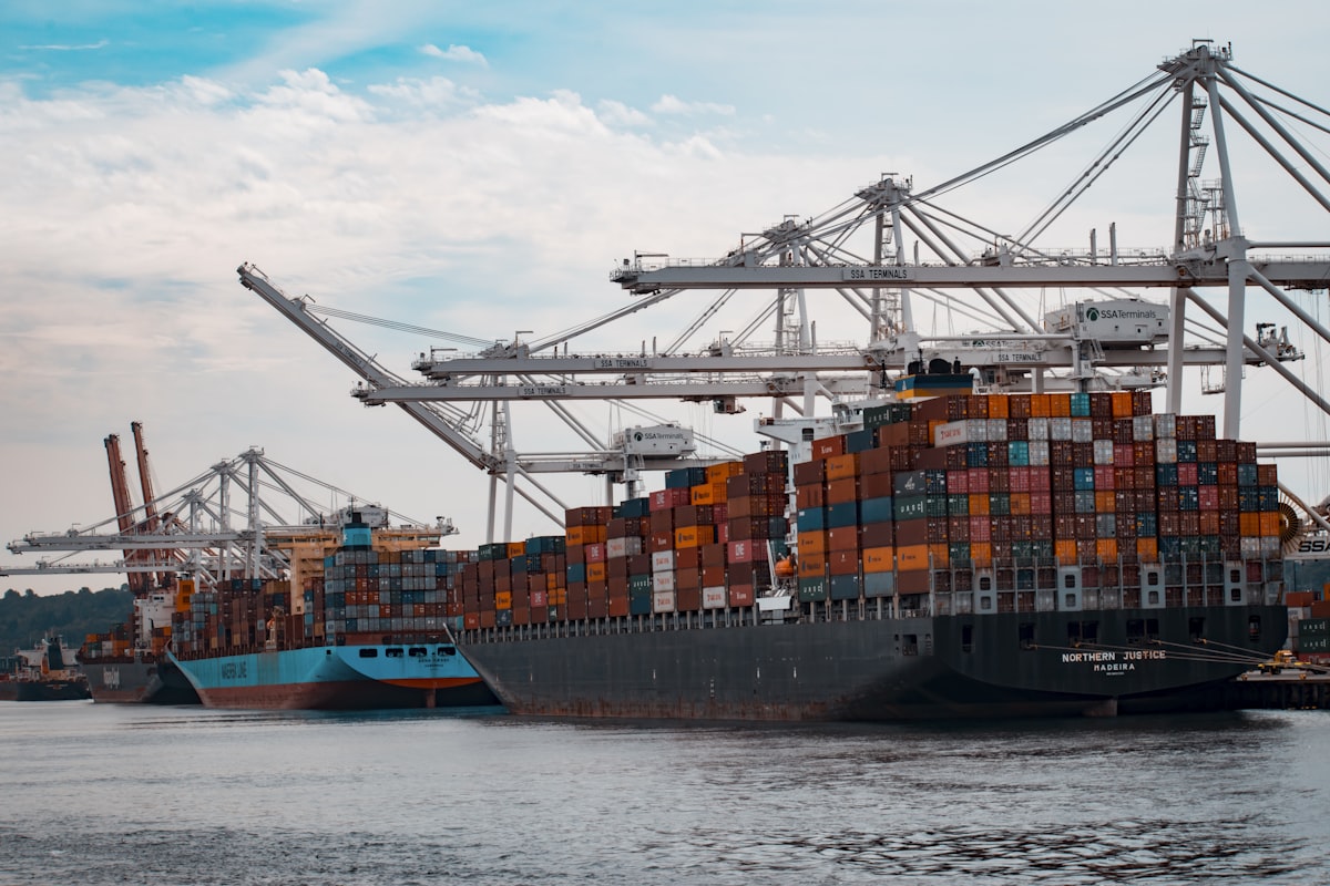 Container ship navigating ocean freight trade corridor with dry and reefer containers